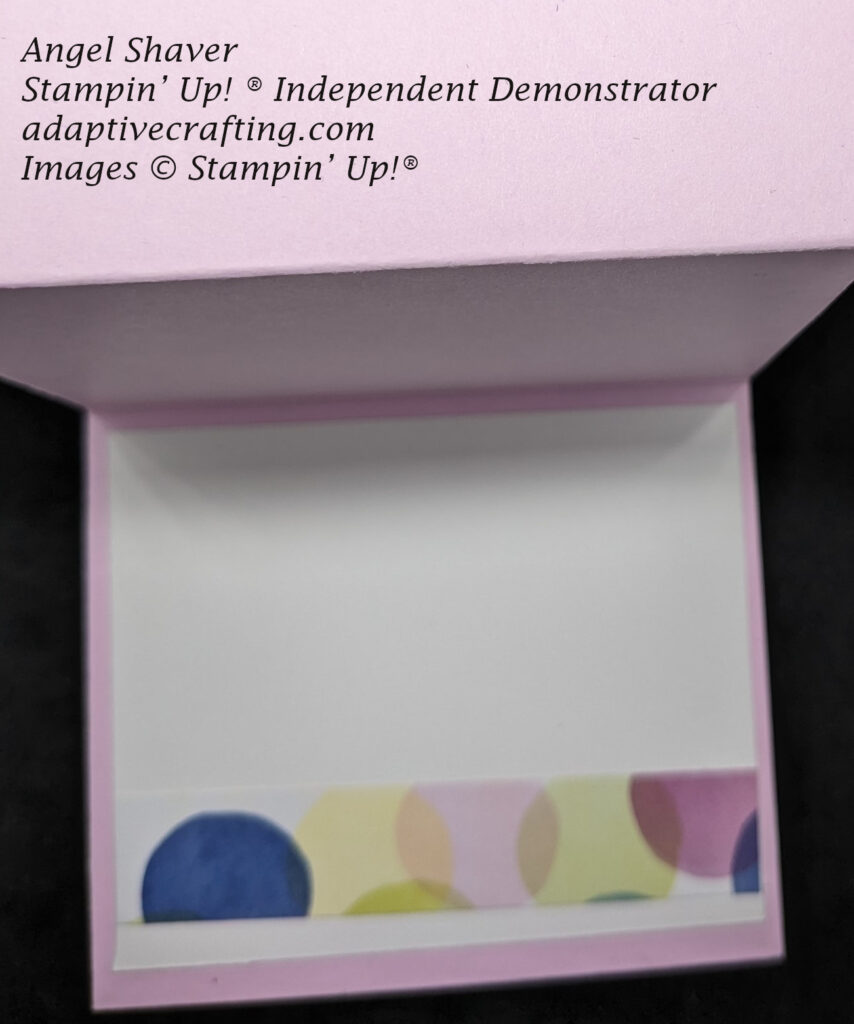 Inside of card  showing a white panel with strip of patterned paper with colored polka dots.