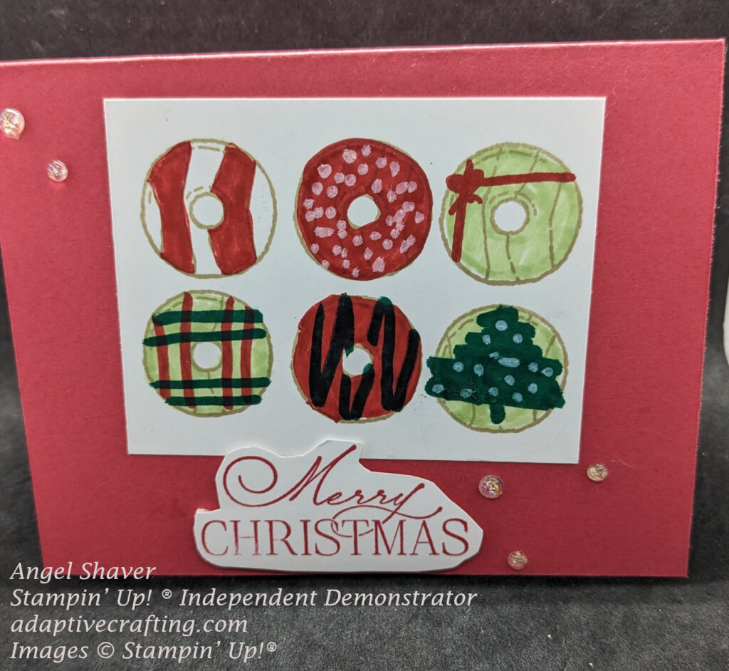 Red Christmas card with six donuts decorated in red & green Christmas decor.  Sentiment says, "Merry Christmas"