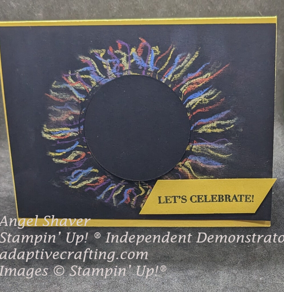 Yellow card with black card front with image representing a solar eclipse.  Circle cut out of the black card front and replaced back in same hole with dimensionals.  Pastels create suns corona.  Yellow sentiment label says, "Let's Celebrate!"
