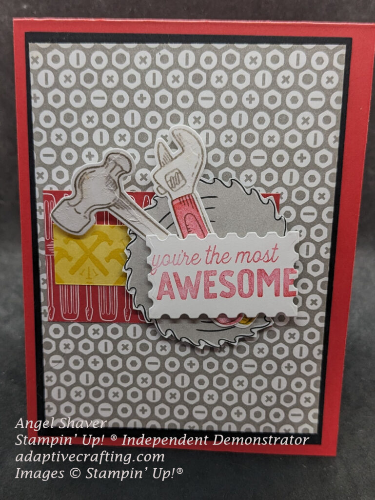 Red card with lots of layers.  Black full size layers topped by patterned paper with tops of screws and nuts.  Topped by strips of patterned paper featuring screwdrivers and hammers.  Topped with a circular saw blade, hammer, and wrench.  Sentiment label says, "You're the most awesome."