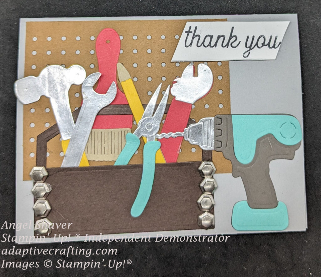 Gray thank you card with diecuts of peg board, tool box, and tools.  Red paint brush hanging from peg board.  Hammer, wrenches, pliars, and pencil in tool box.  Drill sitting beside tool box.