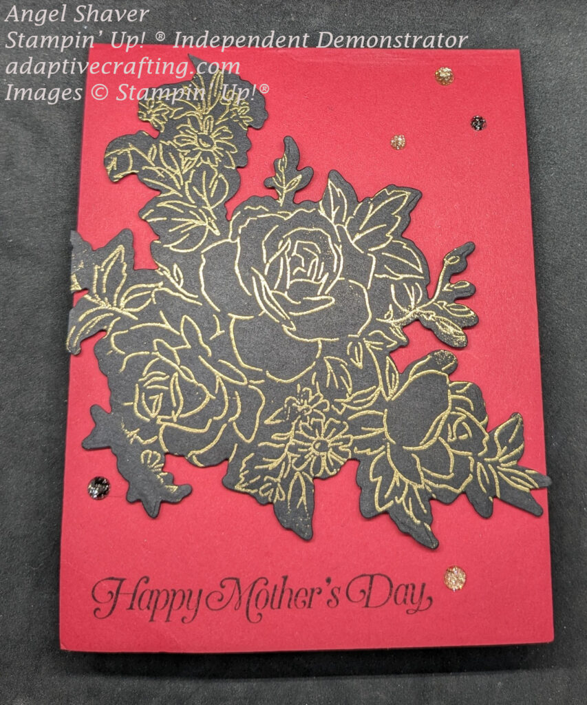 Red Mother's Day card with large die of gold heat embossed roses and other flowers on black.  "Happy Mother's Day" is stamped at the bottom of the card.  Card is finished with black and gold sparkle gems.