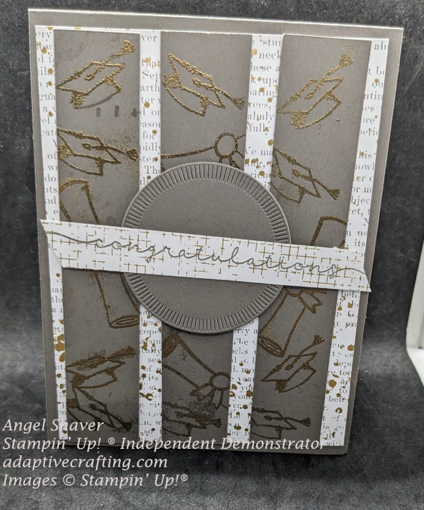 Gray card with white late with words and gold splatters.  Three gray rectangular columns are on top of that with gold heat embossed graduation caps and diplommas.  The top focal point is a circle die with line border and a sentiment label that says congratulations