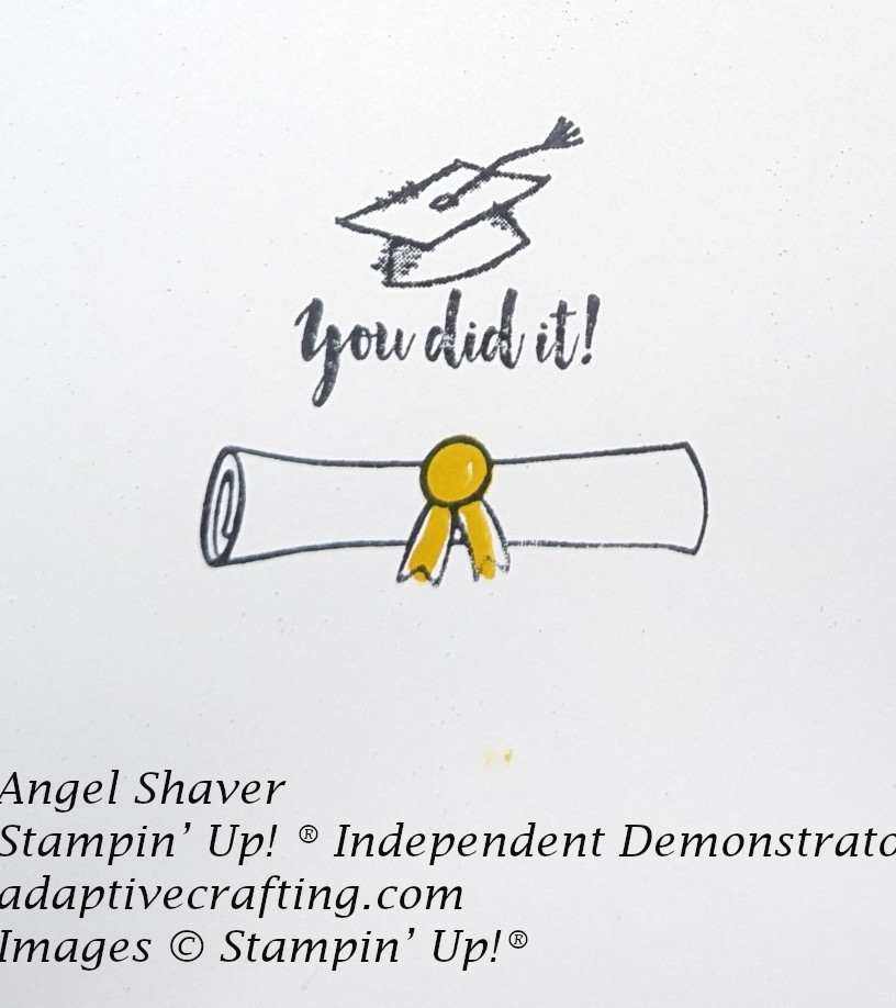 Inside of card with black stamped graduation cap  and sentiment "You did it!" and black outline of diploma with yellow ribbon.