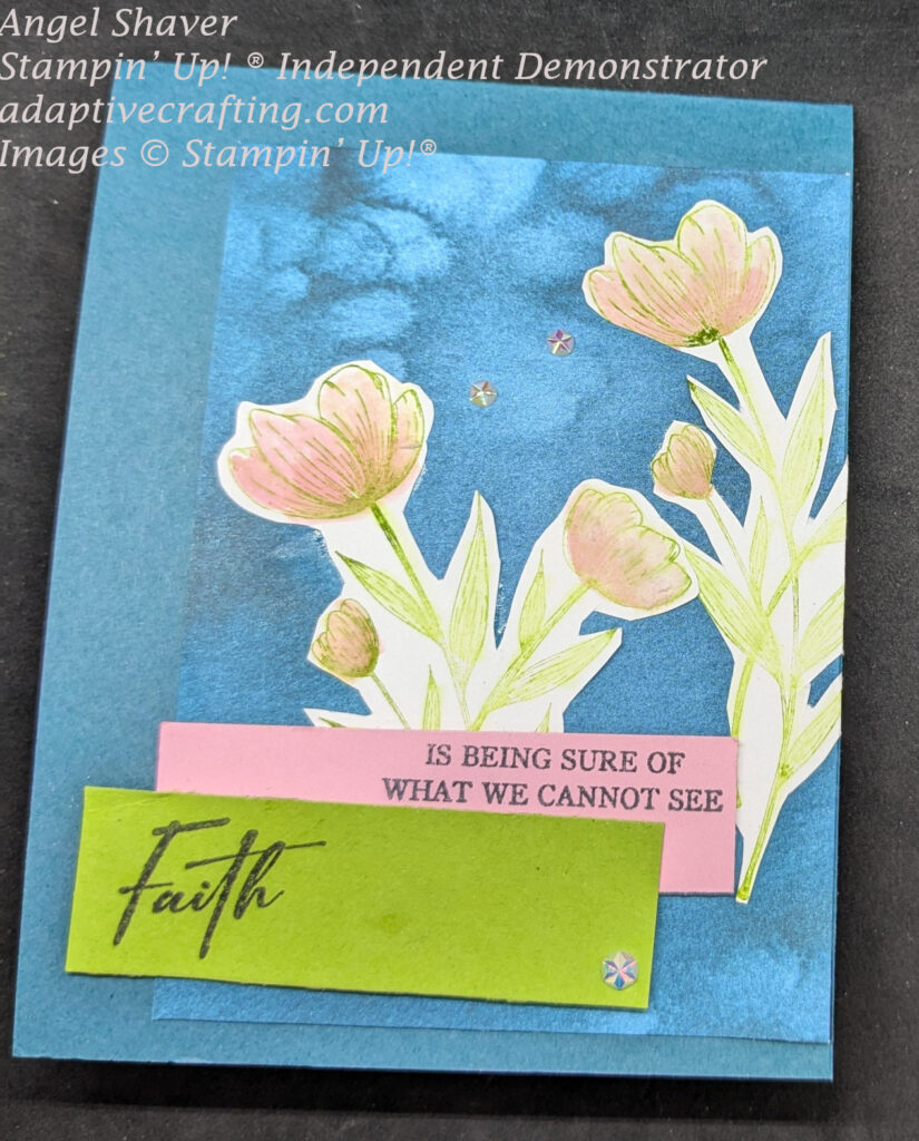 Teal card with rectangle of teal patterned paper with two bundles of pink flowers.  There is a green sentiment label that says "Faith" with a pink label behind that says, "is being sure of what we cannot see."  Card decorated with iridescent faceted gems.