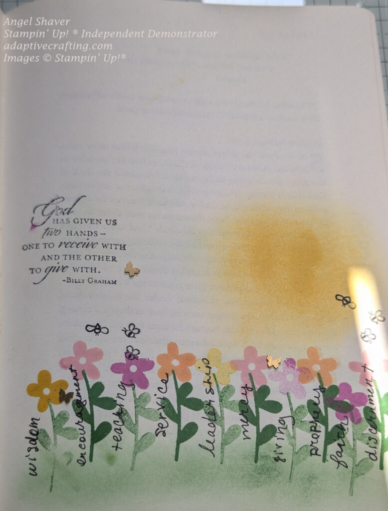 Bible journaling page with ink blended pale blue sky, yellow sun, and green grass.  There are stamped flowers growing in the grass.  They are yellow, pink purple, and peach.  Tge flowers are labeled with spiritual gifts: wisdom, encouragement, teaching, service, leadership, mercy, giving, prophecy, faith, discernment.  There are stamped bees and butterfly embellishments around the flowers.  Page also says, "God has given us two hands--one to receive with and the other to give with."--Billy Graham