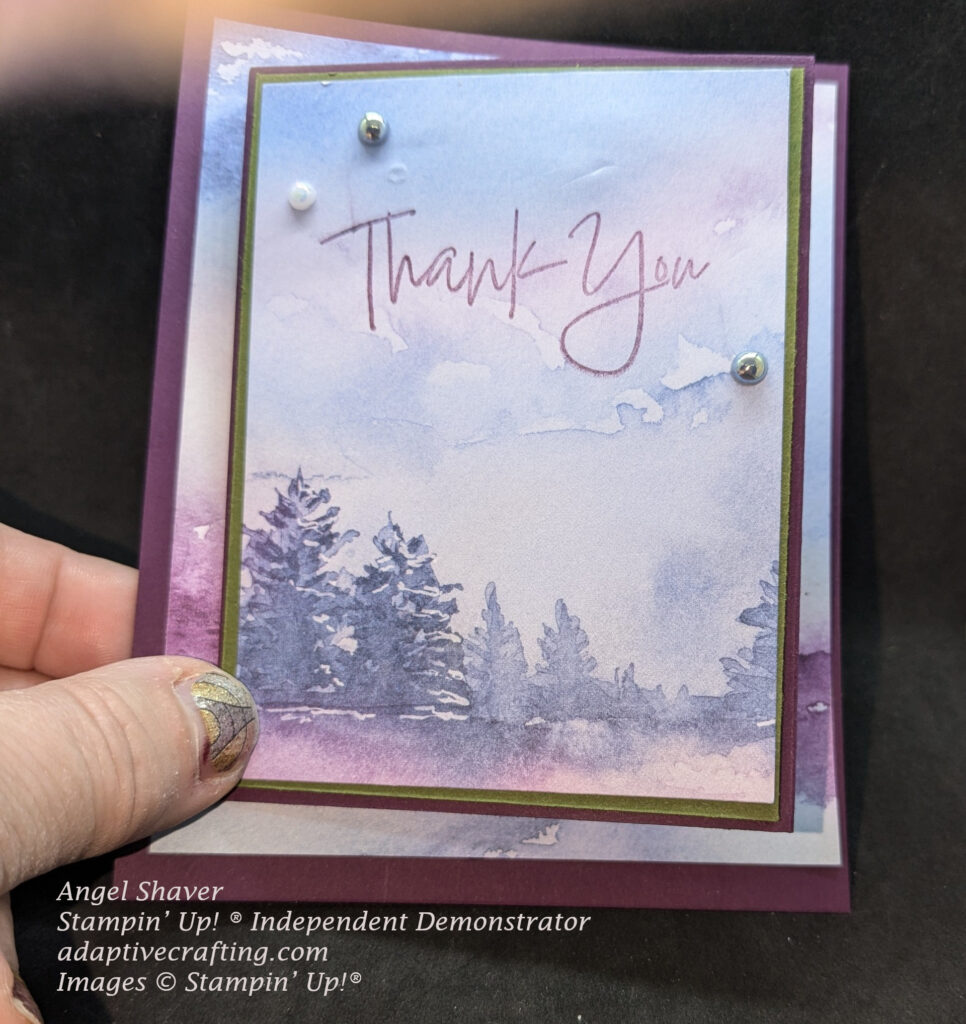 Purple thank you card with patterned paper front with blues and purple sky.  There is a line of blue trees.  Sentiment says "thank you" and is decorated with white and blue pearls.