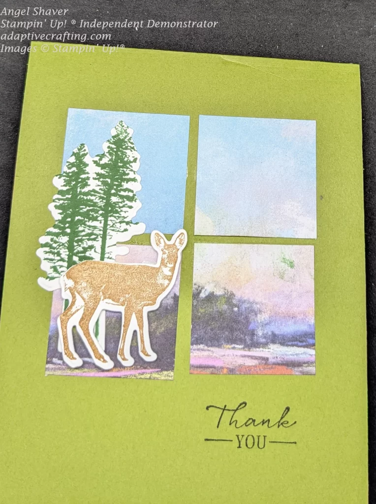 Green thank you card with four panels of a scene with blue skys and trees.  Die cuts of a deer and green trees is the focal point of the card.  Sentiment says, "Thank you"