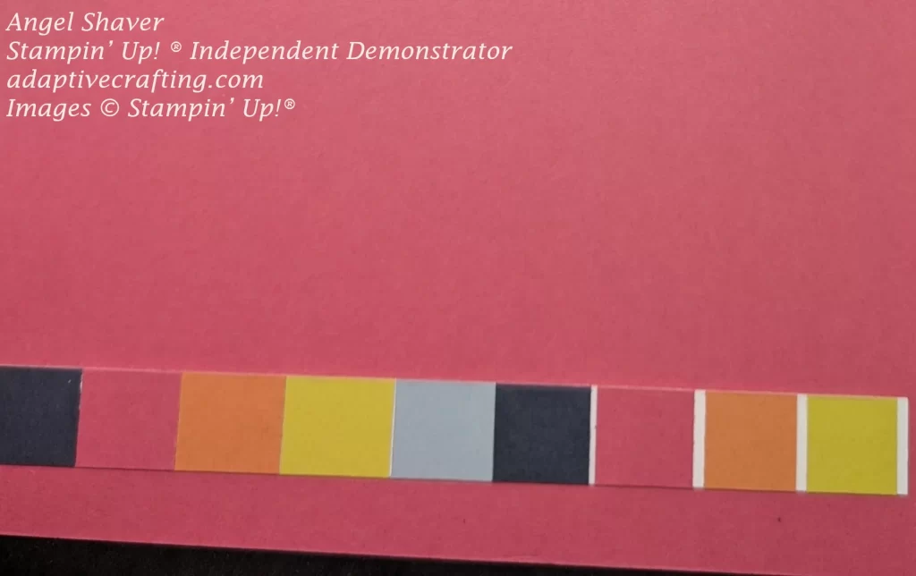 Pink inside of card with strip of alternating cardstock squares in dark blue, pink, orange, yellow, and light blue.