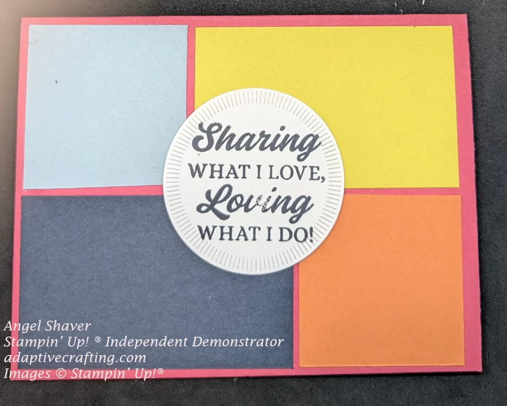 Pink card with panels that are light blue, yeloow, dark blue, and orange.  Circle die in the center front says, "Sharing what I love, Loving what I do!"