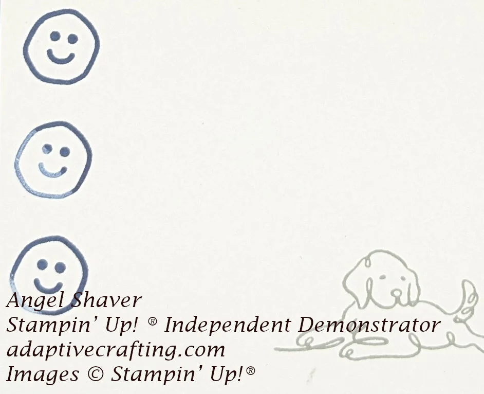 Inside of card with dog stamped on bottom right corner and three smiley face stamped up left edge.