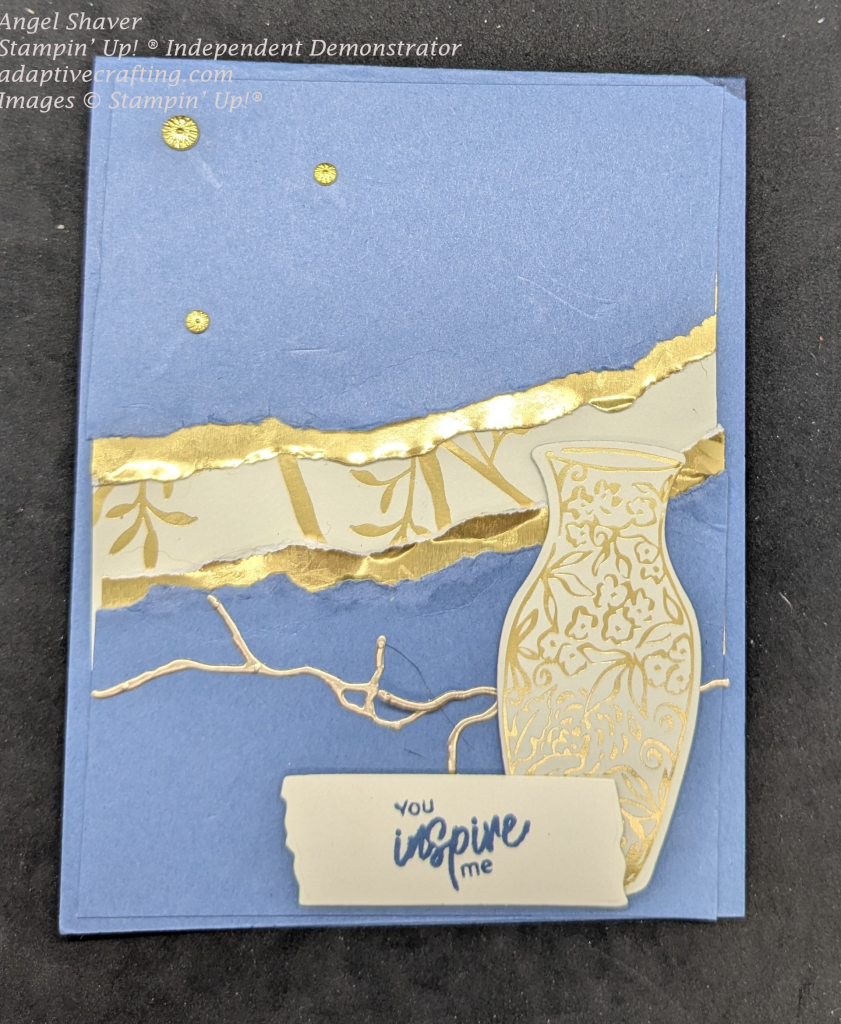 Blue fault line card with gold foil and patterned paper with gold banboo showing through the crack.  There is a gold foil crack under the fault line.  A vanilla vase with gold flowers at the bottom of the page and a sentiment label that saysm "You inspire me"