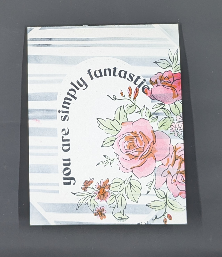 White card with blue stripes.  White arch in the center of the card with arched sentiment that says, "you are simply fantastic."  Flower bundle with pink roses and other flowers and lots of green leaves is along right side of card.