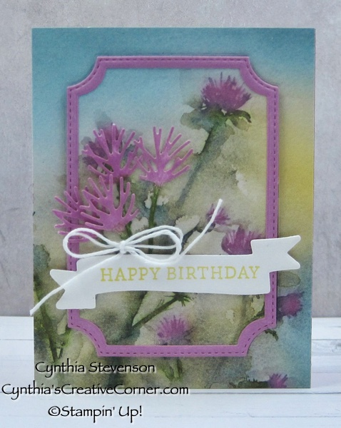 Card made with patterned paper showing purple flowers.  The center of the patterned paper was cut out and frame with a purple die.  Sentiment label says, "Happy Birthday"