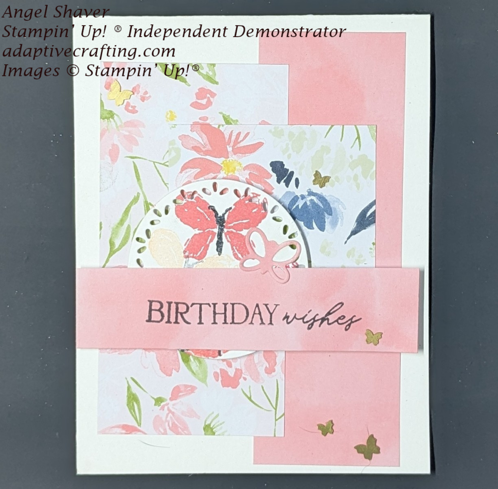 White birthday card with strips of patterned paper that is solid pink or has pink, blue, and white flowers.
Circle die is stamped with butterflies and has butterfly die. Pink sentiment strip says, "Birthday Wishes" Brass butterfly embellishments finish the card.